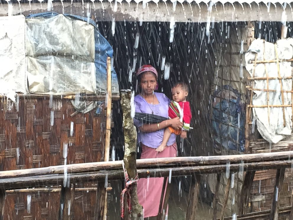 PHOTO: A young Rohingya woman and child in the rain. 