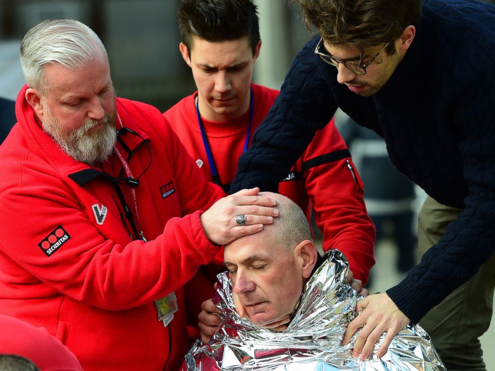 PHOTO: A victim receives first aid on March 22, 2016 near Maalbeek metro station in Brussels, after a blast at this station near the EU institutions caused deaths and injuries.