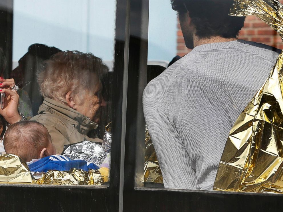 PHOTO: People in thermal blankets are driven from the scene of explosions at Zaventem airport near Brussels, Belgium, March 22, 2016.